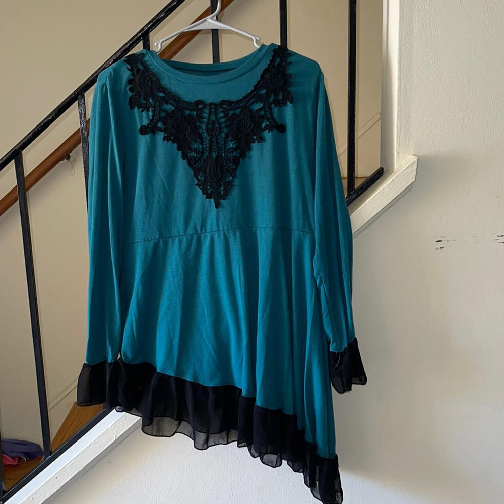 Tunic style teal blouse with lace bell sleeve.